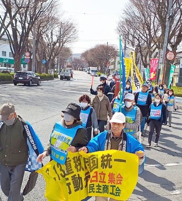 デモ行進でアピールする参加者たち